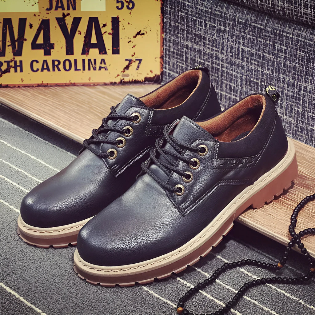 Men's black casual lace-up shoes with a round toe and low-top design on a rubber sole.