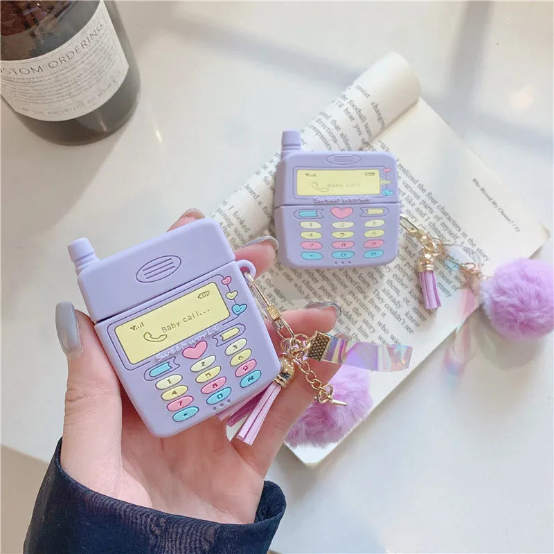 Purple silicone protective case for Apple AirPods with a white fur ball pendant attached.