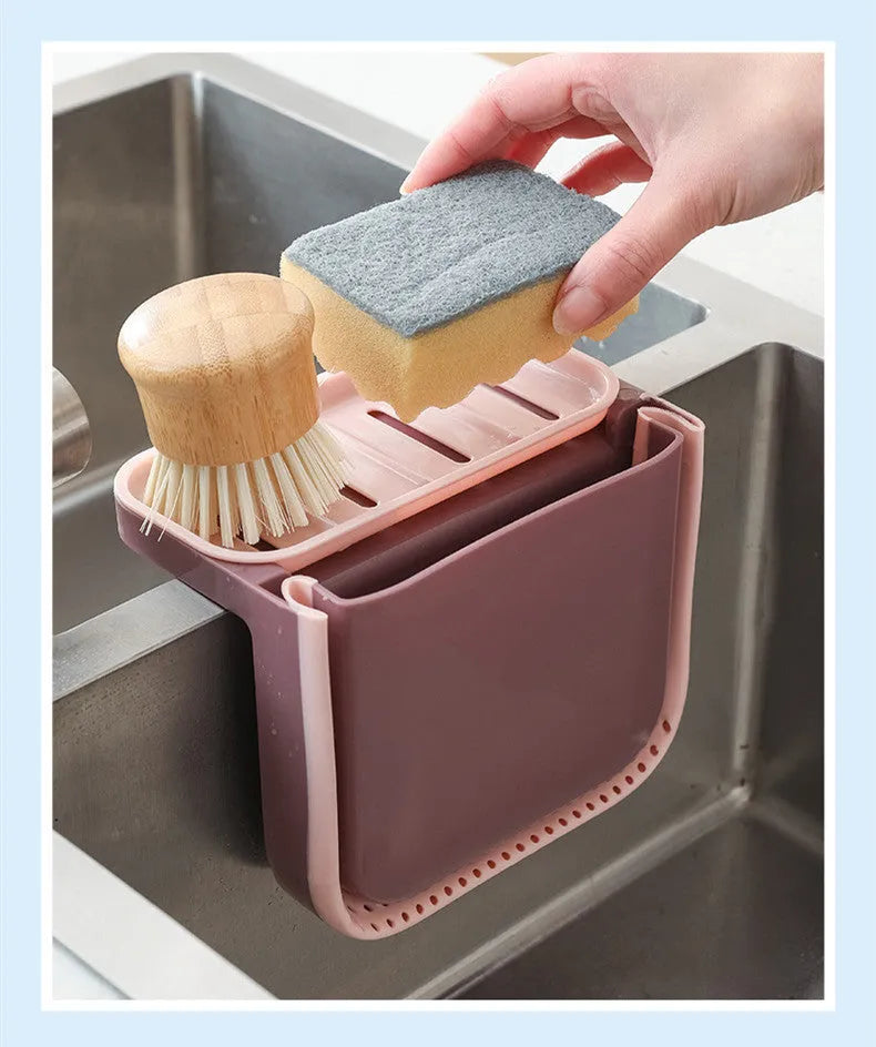 Foldable grey kitchen sink drain basket with suction cup hanging on sink edge
