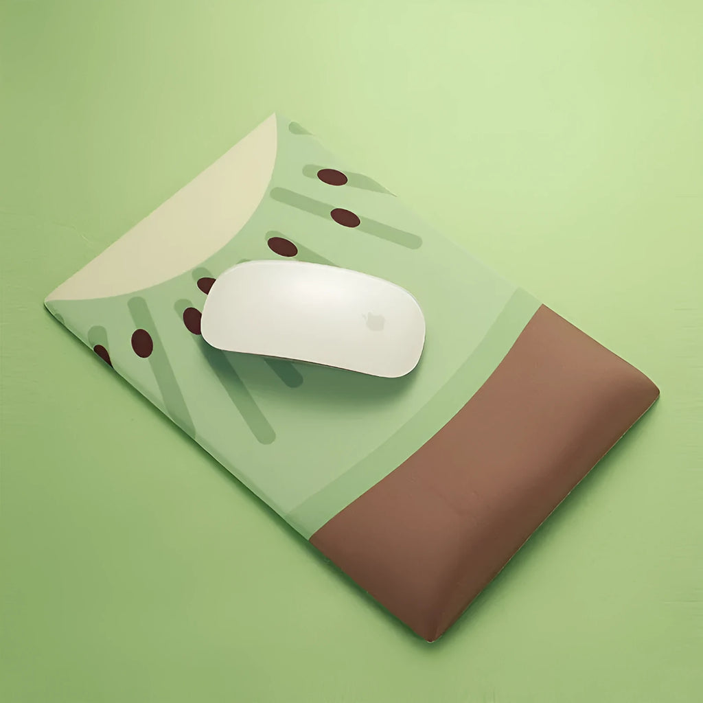 Green kiwi fruit themed mouse pad with integrated thick grey wrist support cushion on a desk.