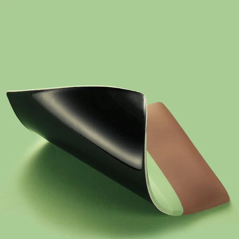 Green kiwi fruit themed mouse pad with integrated thick grey wrist support cushion on a desk.