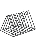 Wrought iron triangle book stand in black on a desk holding a book upright