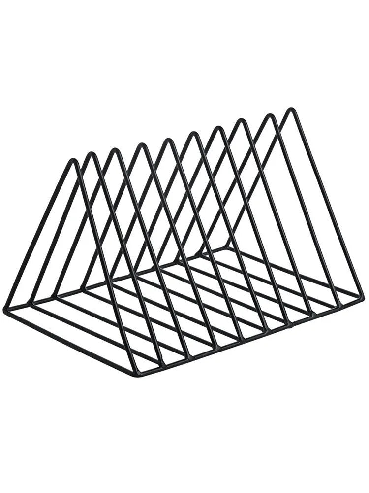 Wrought iron triangle book stand in black on a desk holding a book upright