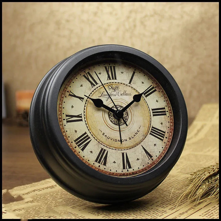 European retro style round desk alarm clock with silent sweep movement on a wooden surface.
