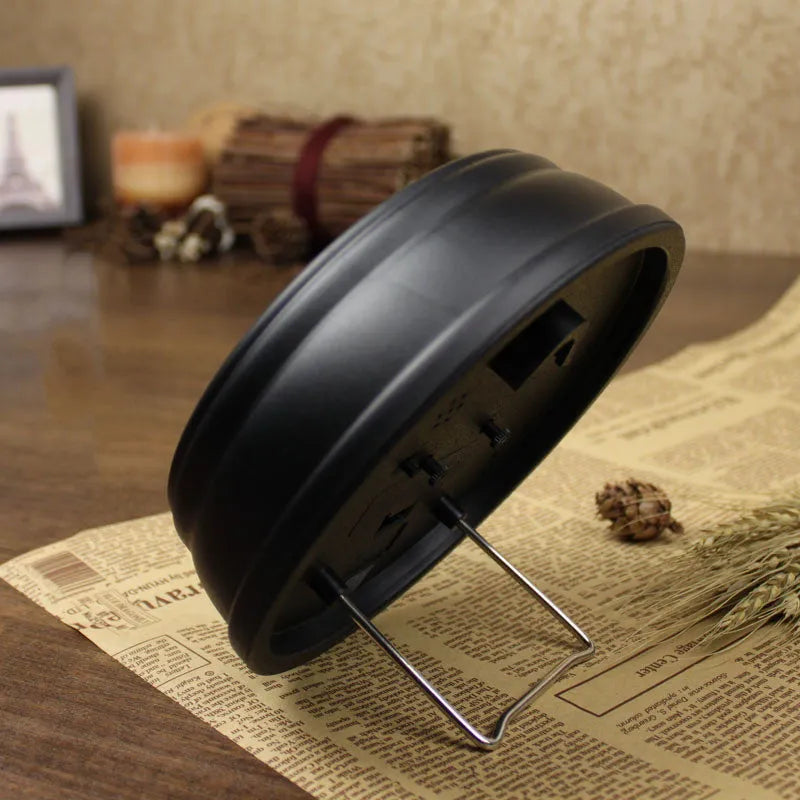 European retro style round desk alarm clock with silent sweep movement on a wooden surface.