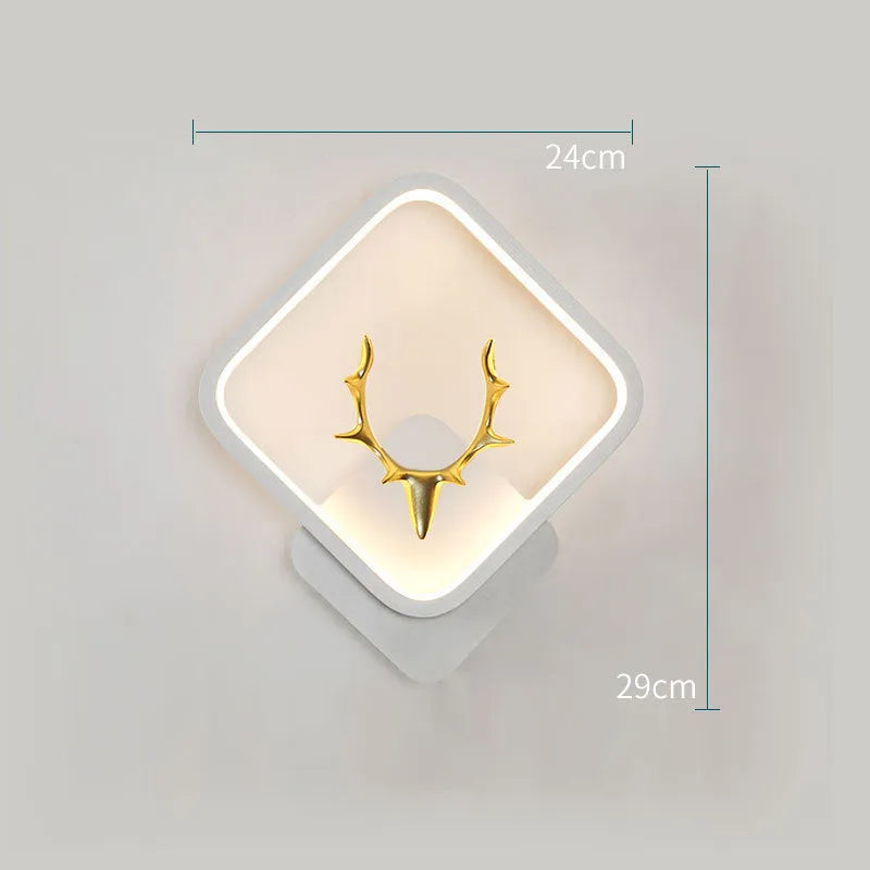 Deer antler shaped wall lamp with remote control on a light-coloured wall.