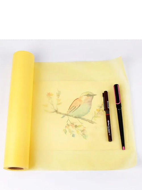 Aikale white and yellow sketch scroll paper rolls showing different widths on a studio table.