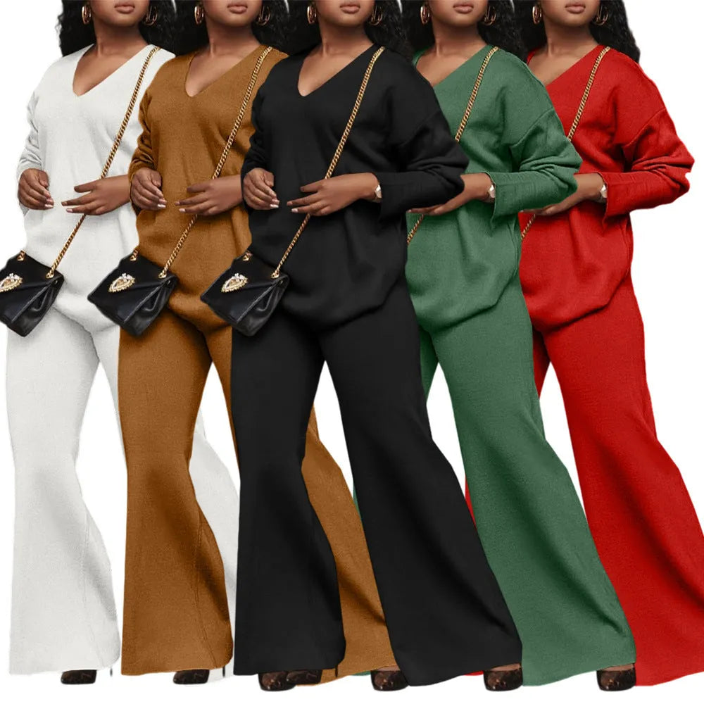 Women's brown thickened suede two-piece suit with split sleeve top and trousers on a hanger.