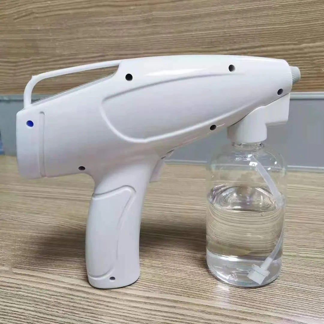 White cordless electric spray disinfection gun with USB-C charging port and bottle.