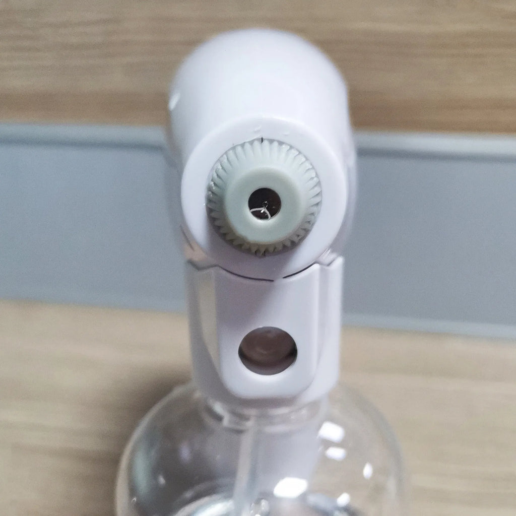 White cordless electric spray disinfection gun with USB-C charging port and bottle.