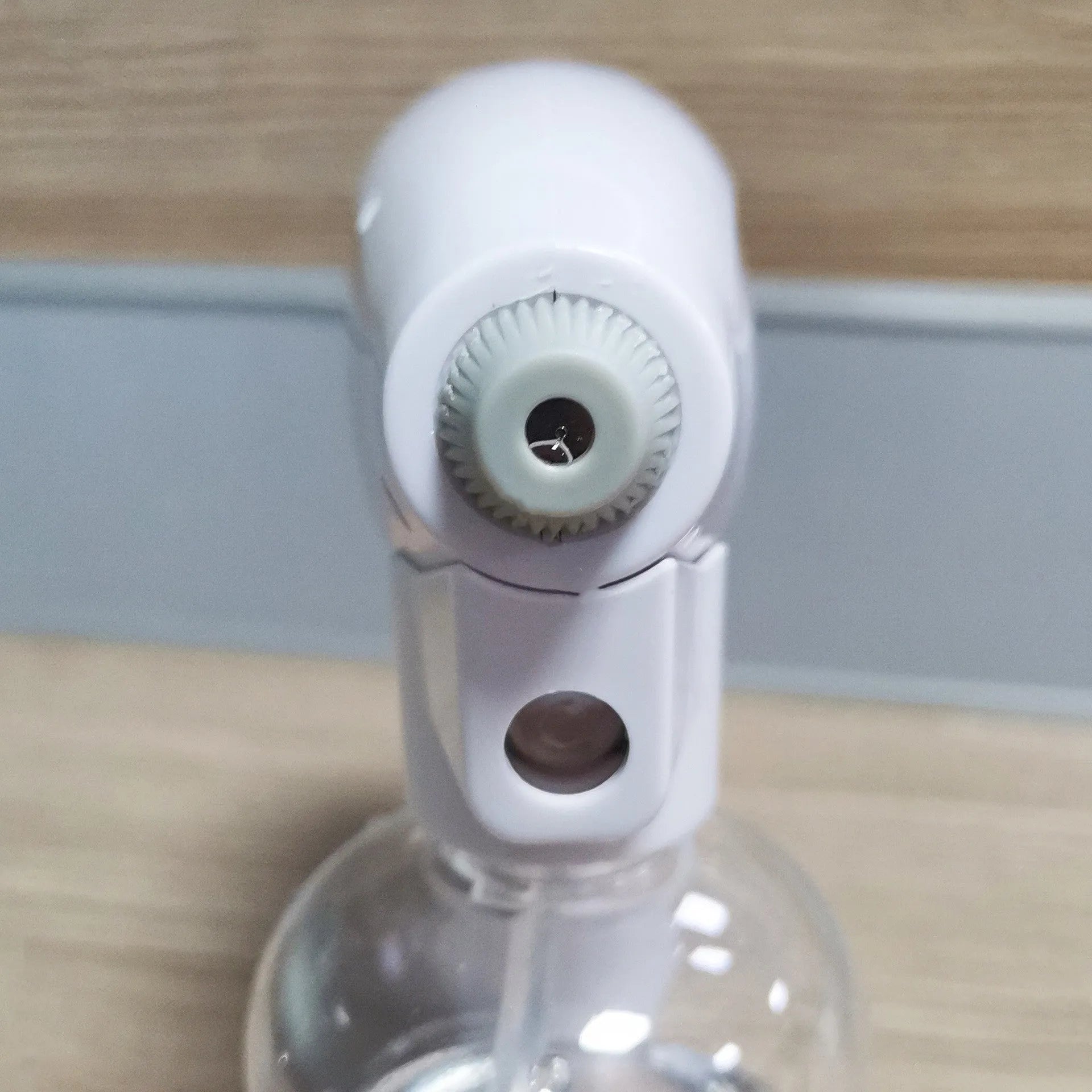 White cordless electric spray disinfection gun with USB-C charging port and bottle.