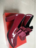 Women's patent leather high heel shoes with thick heels in black colour showing square toe design