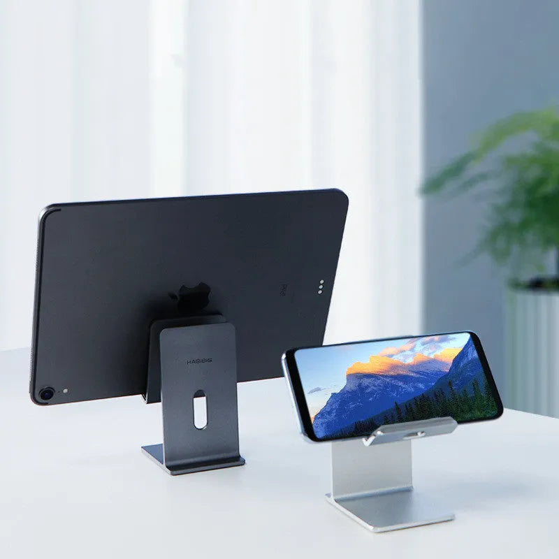 Alloy mobile phone and tablet holder in dark grey or silver on a desk