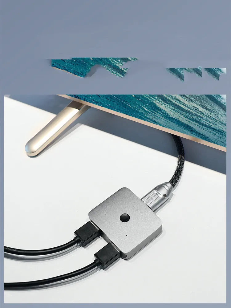 Grey Haibeisi HDMI switcher box with two input ports and one output port for 4K video sharing.
