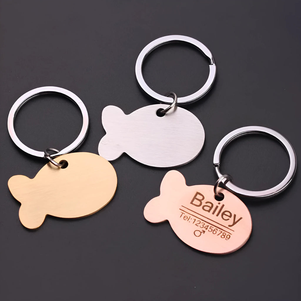 Personalised stainless steel bone-shaped pet ID tag keychain engraved with a name, available in gold, silver, or rose gold