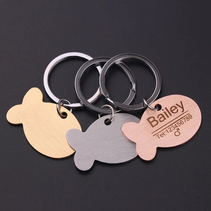 Personalised stainless steel bone-shaped pet ID tag keychain engraved with a name, available in gold, silver, or rose gold