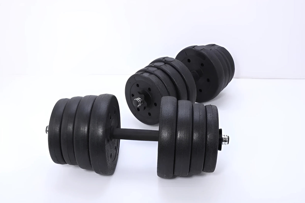 Black round head dumbbell pair 20 kg rubber coated on floor