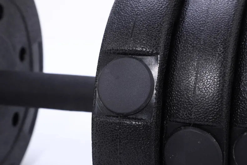Black round head dumbbell pair 20 kg rubber coated on floor