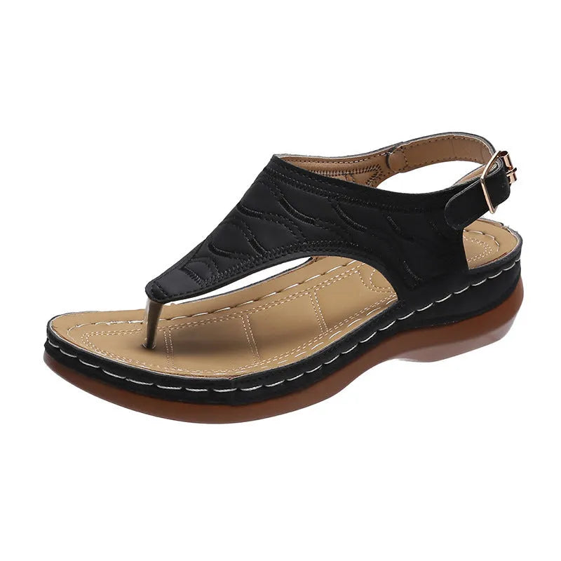 Women's wedge heel sandal in a solid colour with an adjustable back strap buckle.
