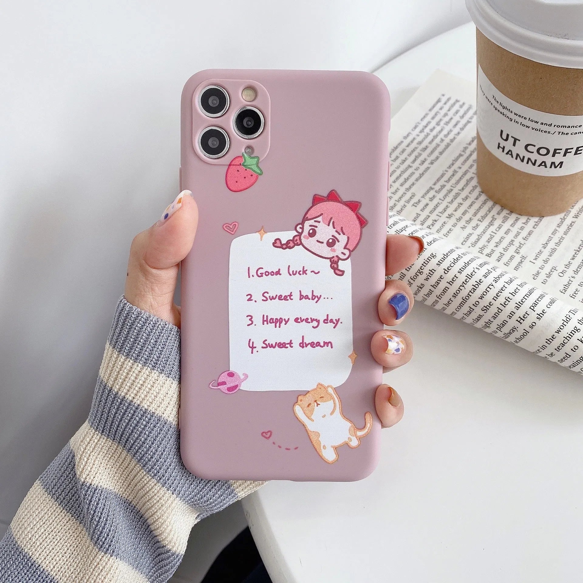Blue soft shell iPhone case with printed cartoon dinosaur design, shown next to a pink version with a cat girl print.