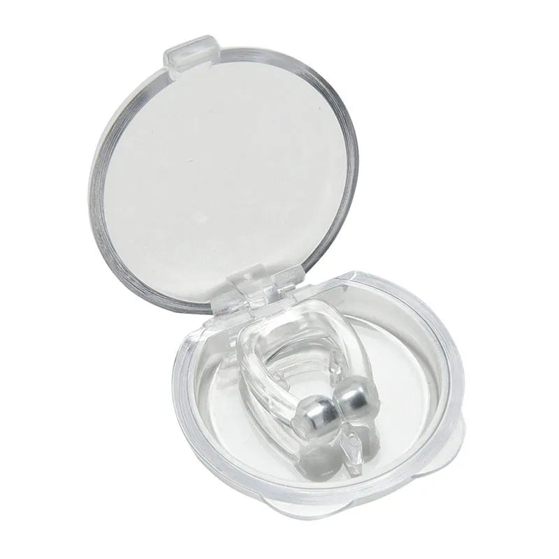 Mini magnetic silicone anti-snoring nose clip in white on a transparent plastic box