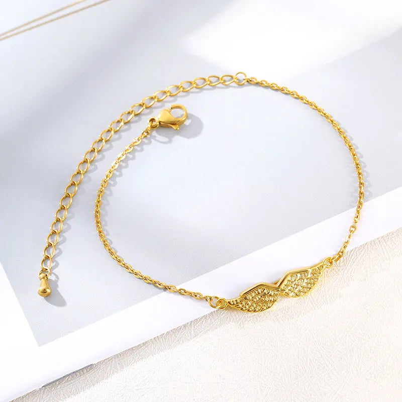 Gold angel wing charm bracelet for women copper electroplate Korean style on white background