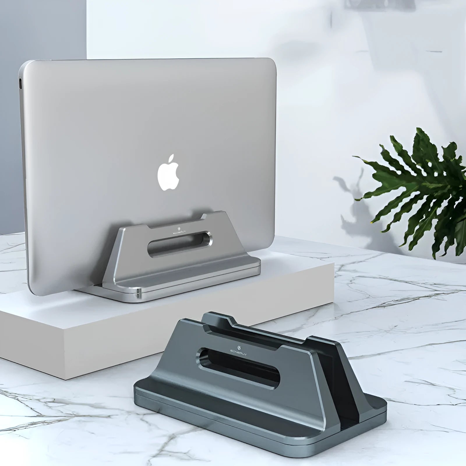 Silver aluminium alloy vertical laptop storage bracket on desk holding a notebook computer
