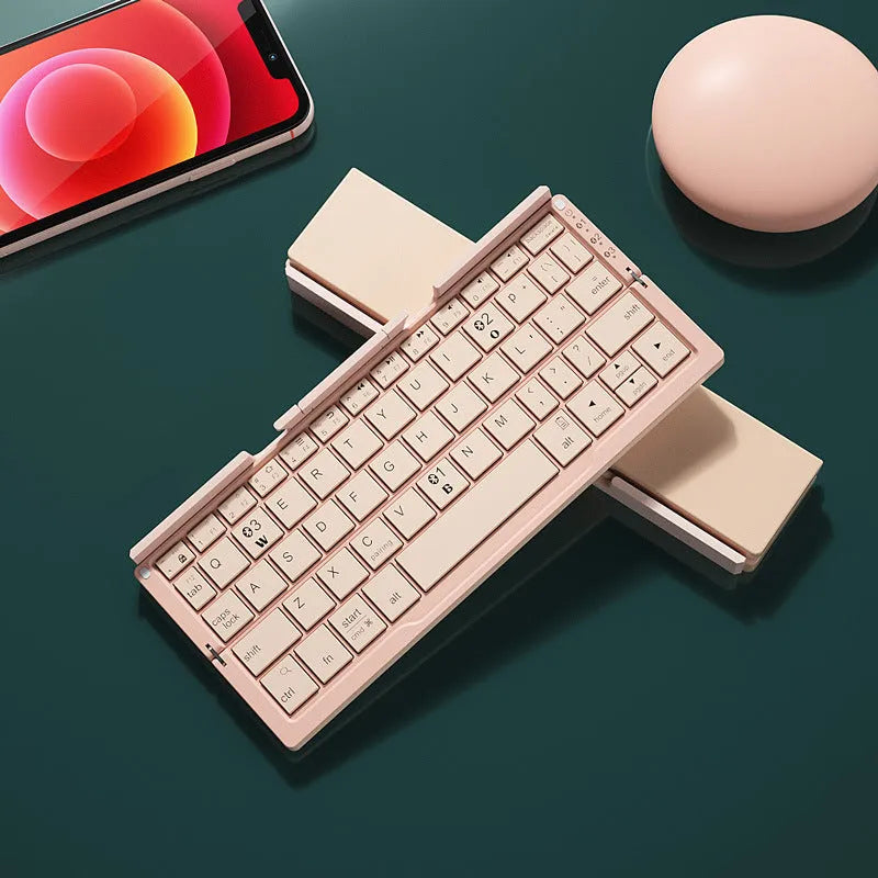 Silver white folding Bluetooth keyboard with integrated phone stand, shown open for typing and folded for storage