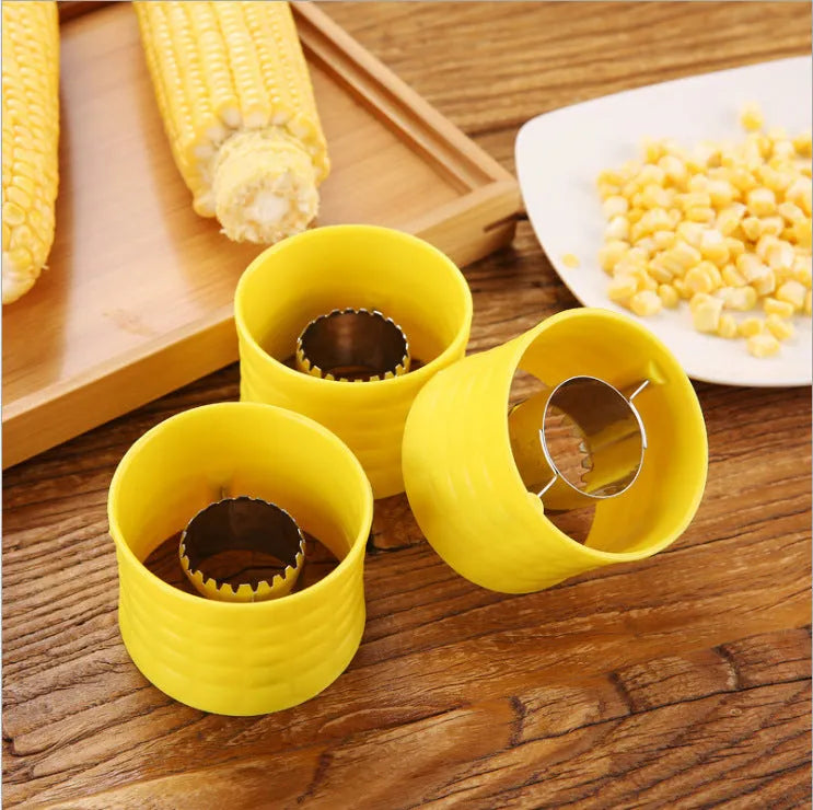 Yellow corn-shaped manual thresher kitchen tool with a non-slip PP grip for removing kernels from corn cobs.