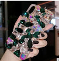 Clear rhinestone crystal gem iPhone case on a mobile phone, showing decorative back detail.