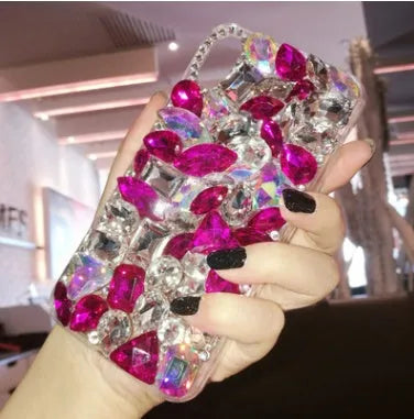 Clear rhinestone crystal gem iPhone case on a mobile phone, showing decorative back detail.