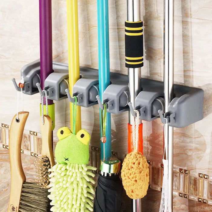 Plastic mop hook wall hanger with 4 hooks for drilling installation, holding a mop and broom