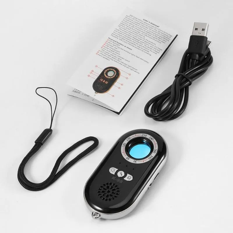 Compact black wireless signal detector alarm with vibration sensor for travel security.