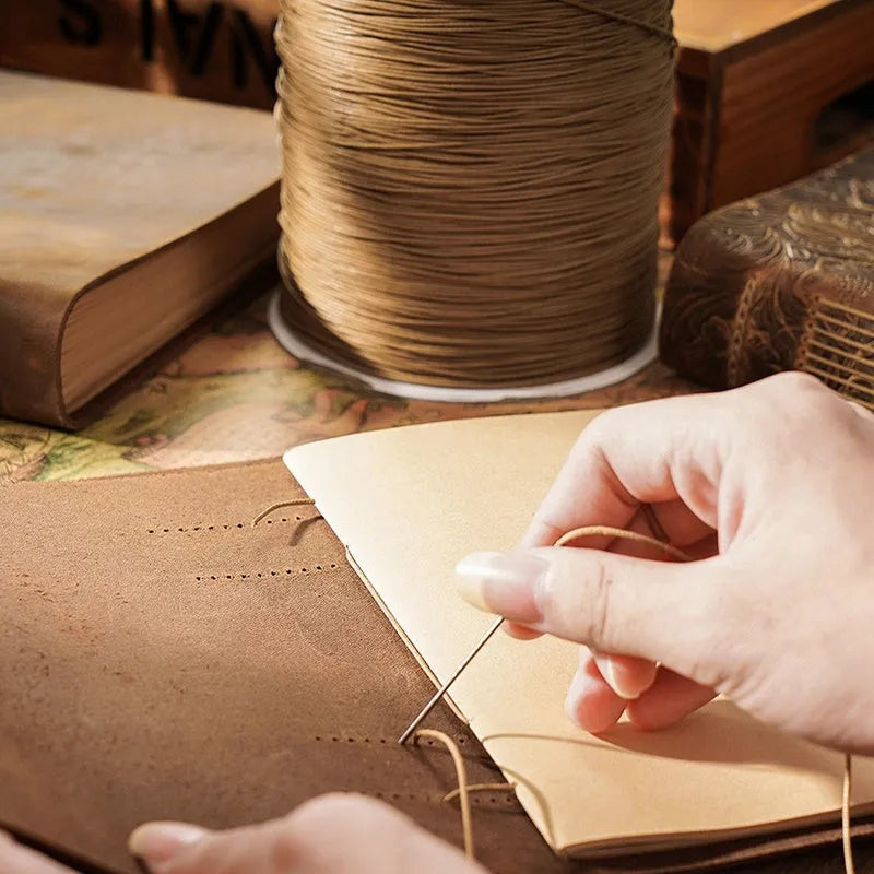 Brown crazy horse leather handmade notebook open on a wooden surface showing 200 pages of Daolin paper