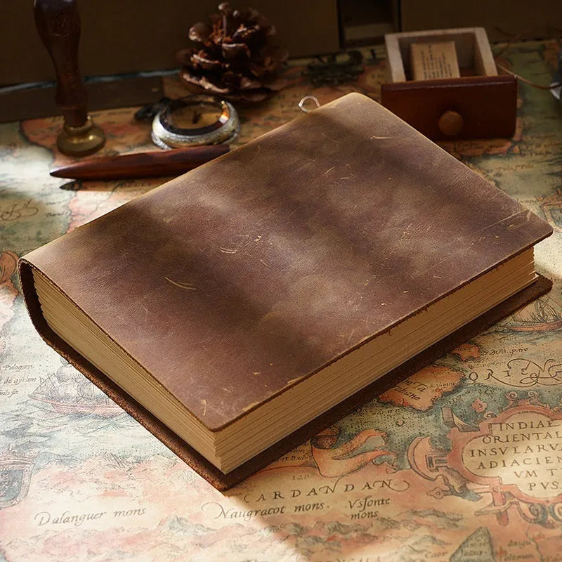 Brown crazy horse leather handmade notebook open on a wooden surface showing 200 pages of Daolin paper