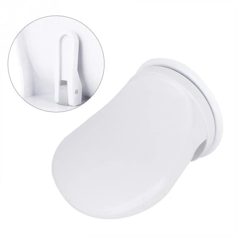 White plastic bathroom shower foot rest with suction cups on smooth tile