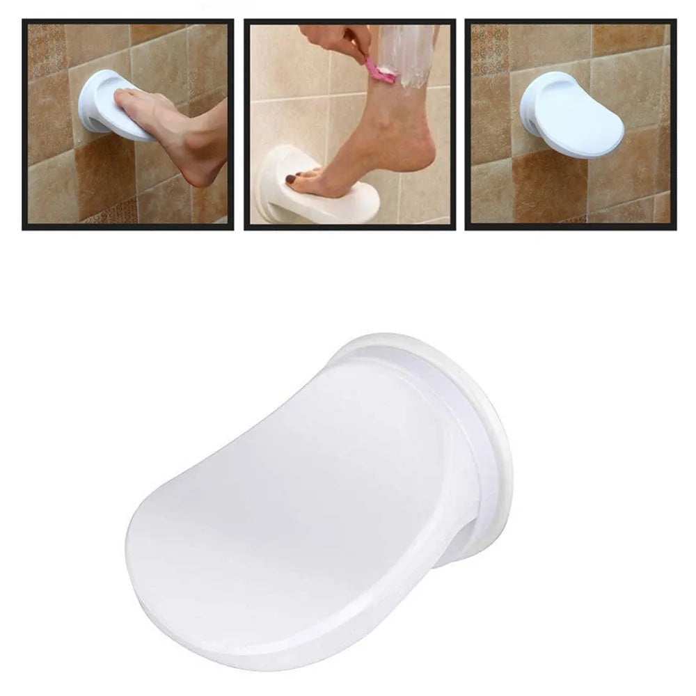 White plastic bathroom shower foot rest with suction cups on smooth tile