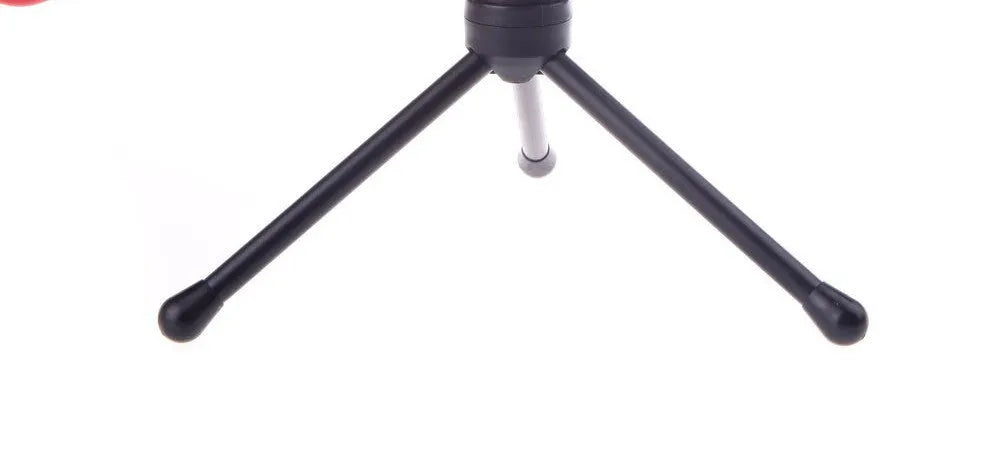 Black wired desktop PC microphone with a metal clip-on holder bracket on a desk.
