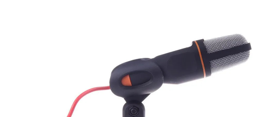 Black wired desktop PC microphone with a metal clip-on holder bracket on a desk.