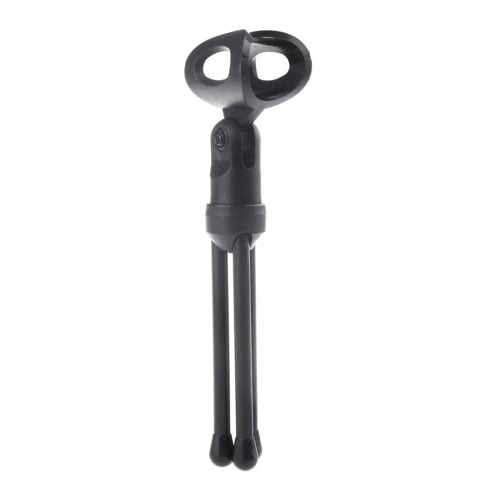 Black wired desktop PC microphone with a metal clip-on holder bracket on a desk.