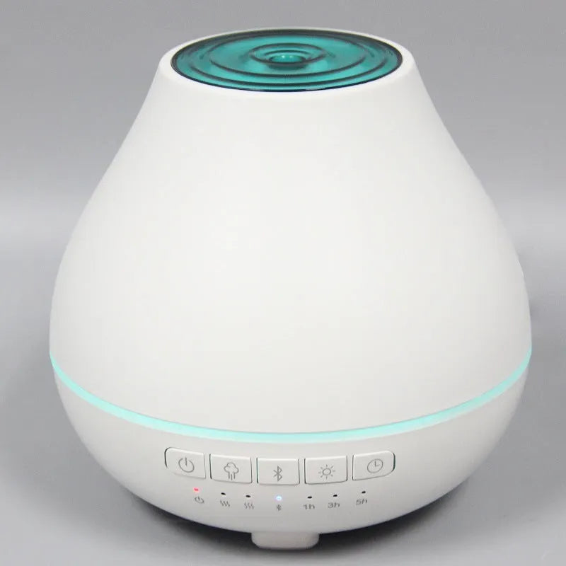 White round Bluetooth humidifier and aroma diffuser with night light function on wooden surface