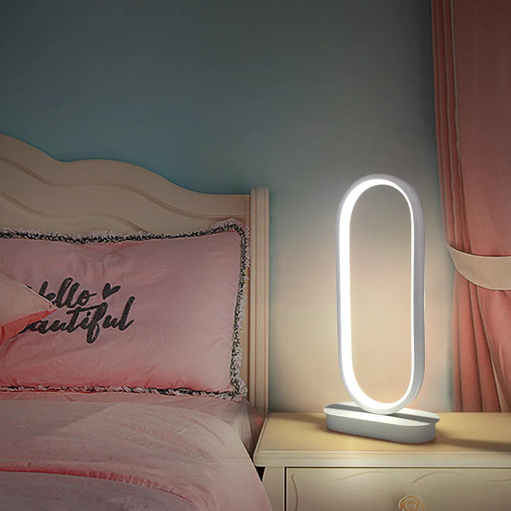 Oval metal LED table lamp 45cm tall with black metal shade on a table