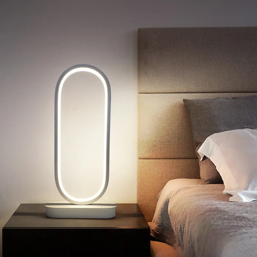 Oval metal LED table lamp 45cm tall with black metal shade on a table