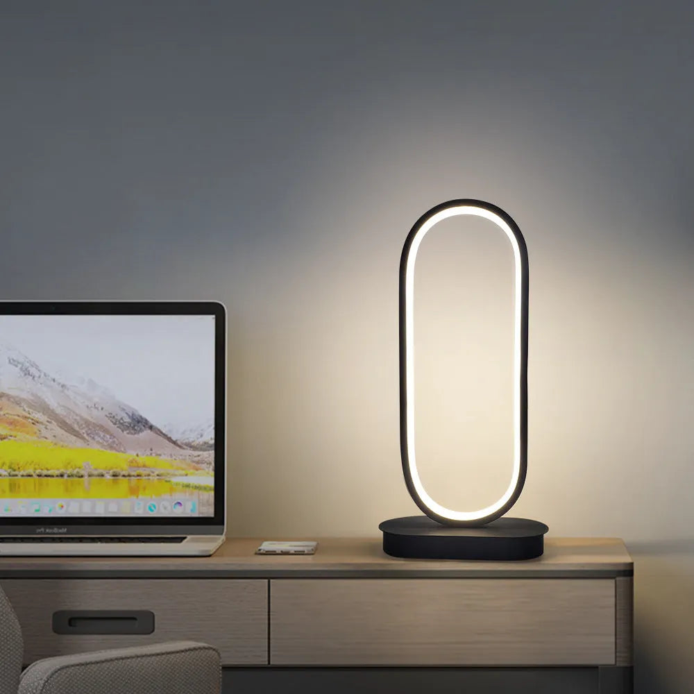 Oval metal LED table lamp 45cm tall with black metal shade on a table
