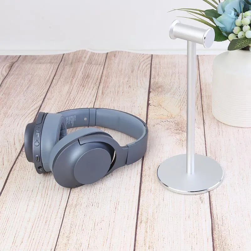 Black aluminium alloy headset bracket on desk holding a headphone for storage