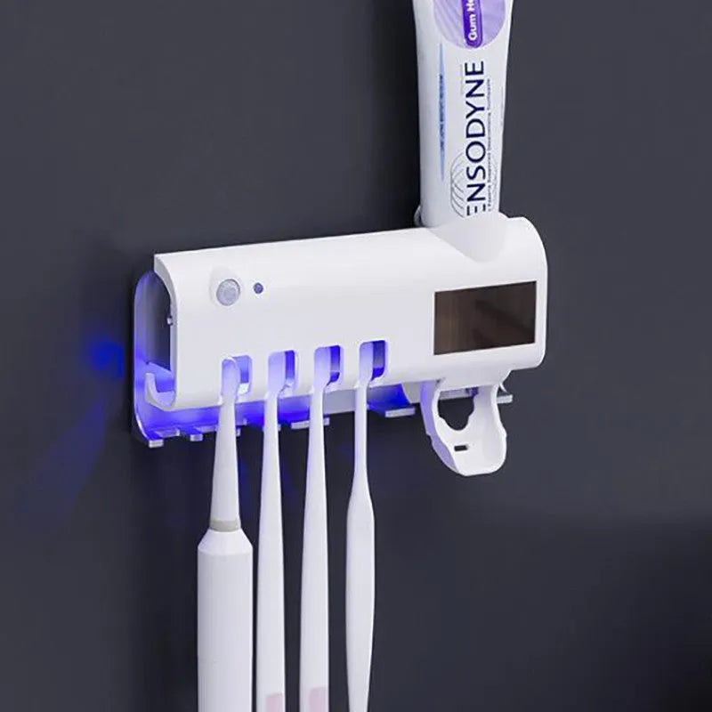 Intelligent UV toothbrush steriliser unit with automatic toothpaste squeezer mounted on wall