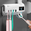 Intelligent UV toothbrush steriliser unit with automatic toothpaste squeezer mounted on wall