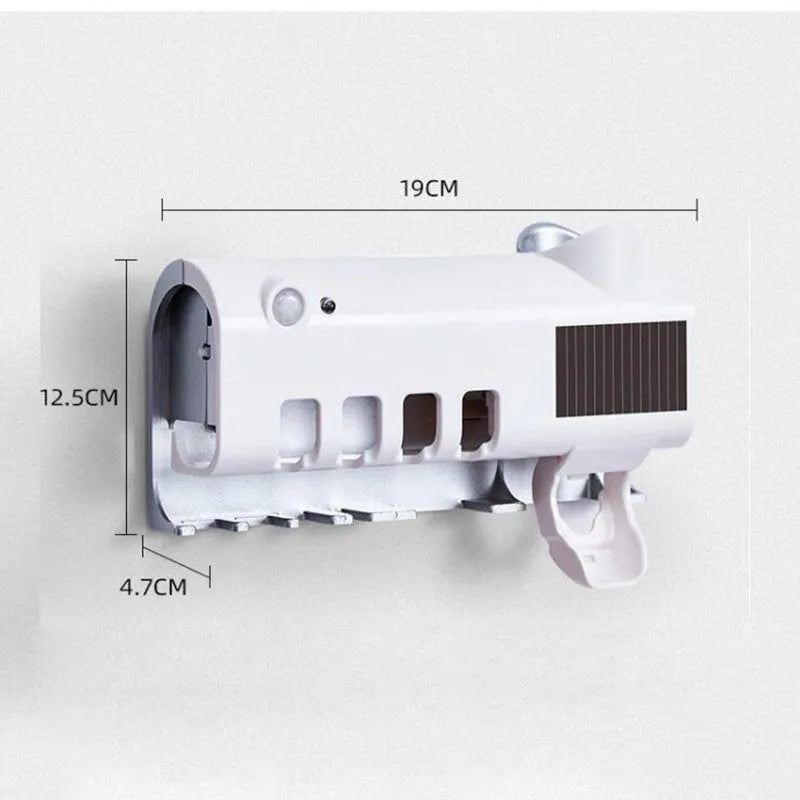 Black and white wall-mounted UV toothbrush steriliser with automatic toothpaste squeezer, showing solar panel and sensor.