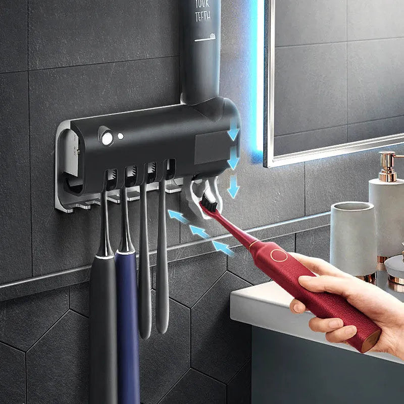 Intelligent UV toothbrush steriliser unit with automatic toothpaste squeezer mounted on wall