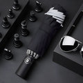 Automatic reverse umbrella showing black canopy with 10 ribs and plastic non-slip handle